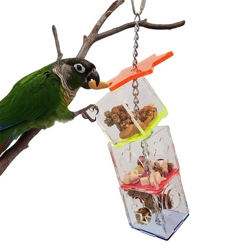 Clear acrylic parrot foraging toy measuring 32cm long, filled with bird treats.