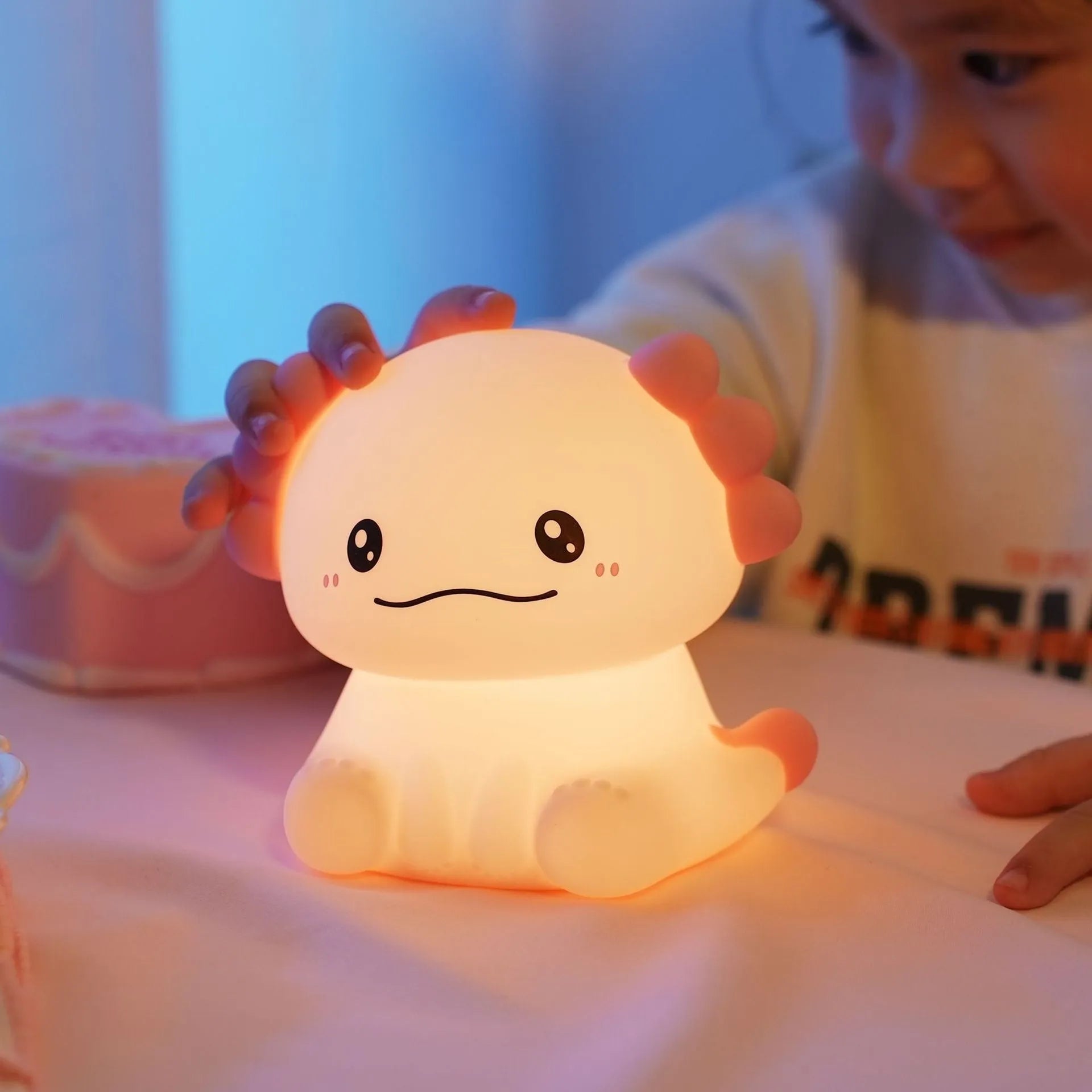 Hexagonal dinosaur silicone night lamp with built-in battery on a bedside table