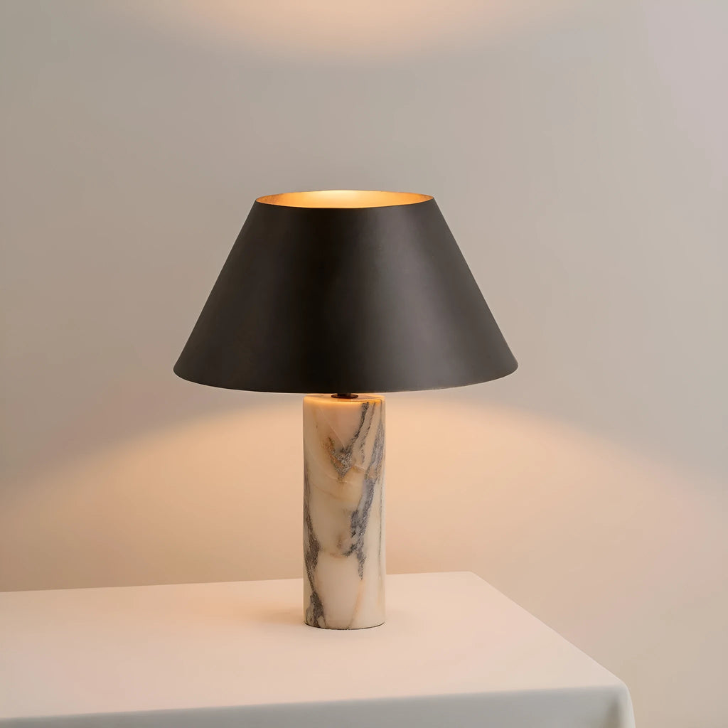 Modern black shade table lamp with marble base on wooden surface