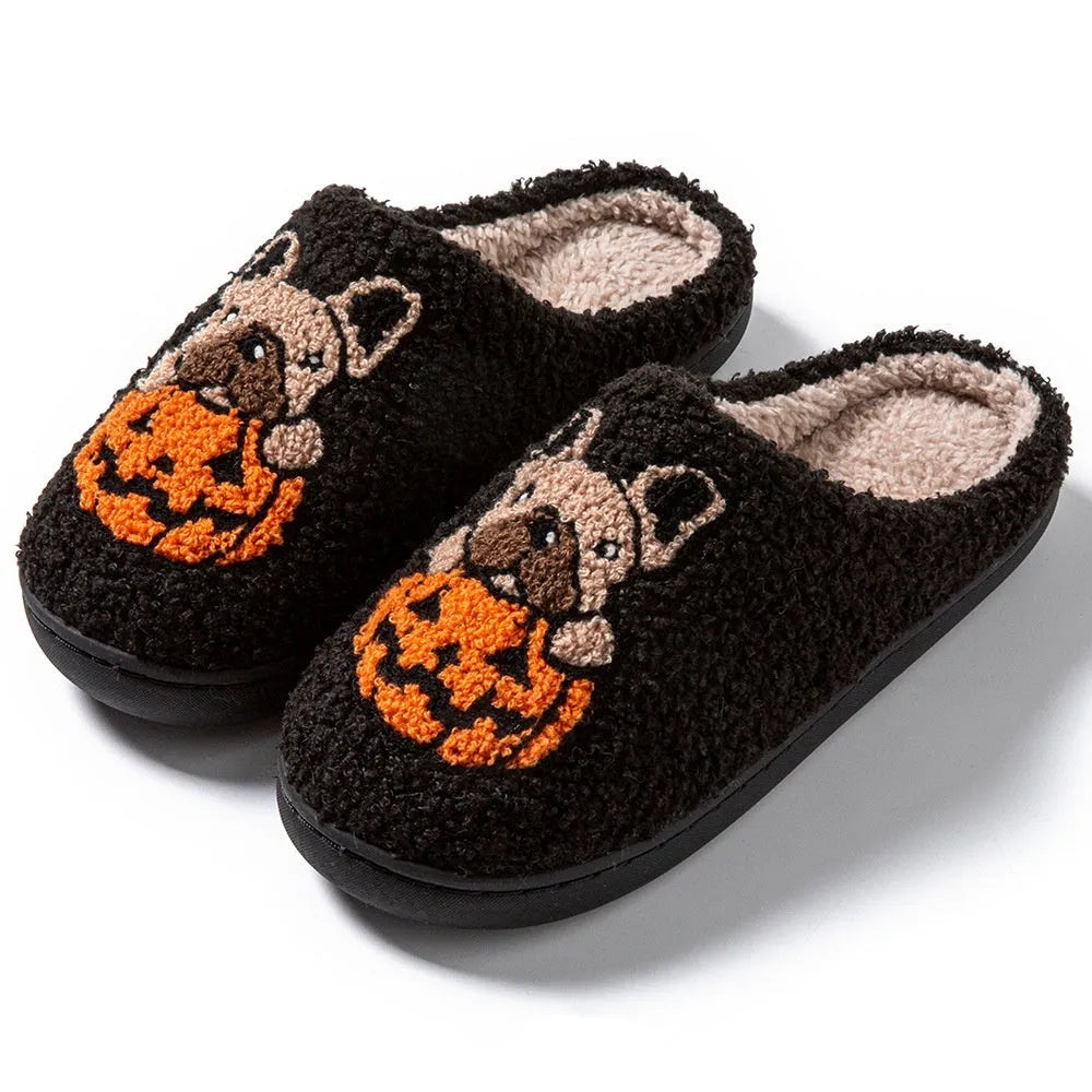 Black and white Halloween slippers with pumpkin design, plush upper, and textured TPR non-slip sole.