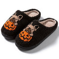 Black and white Halloween slippers with pumpkin design, plush upper, and textured TPR non-slip sole.