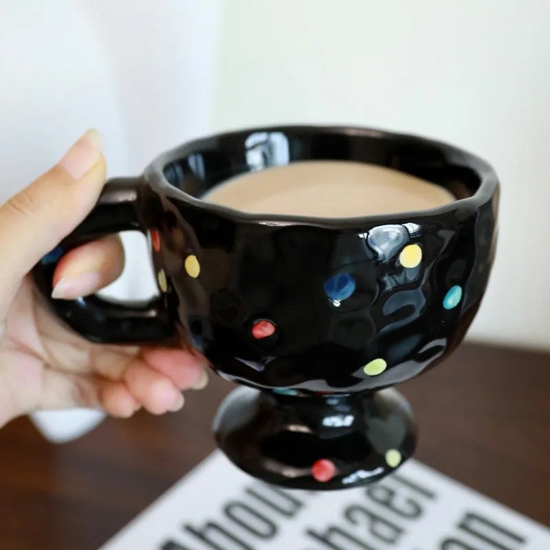 Hand-pinched irregular shaped ceramic mug in a solid colour, showing its unique form.