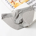 Men's black ice silk seamless briefs with a supportive front pouch on a grey background.