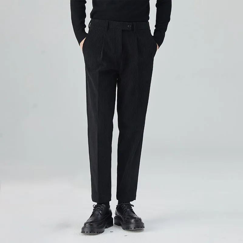 Men's beige corduroy straight leg loose fit trousers with a mid-rise elastic waistband.