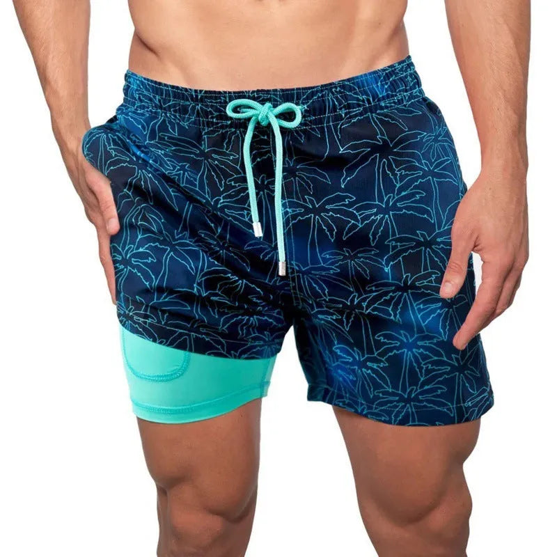 Men's printed double-layer beach shorts in striped cotton blend with elastic waist on a sandy beach
