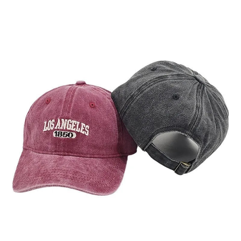 Retro-style adjustable acrylic peaked cap with embroidered letters, shown in a distressed beige colour.
