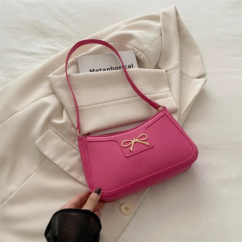 PU leather shoulder bag with bow decoration in a horizontal square shape, shown in one of six available colours.
