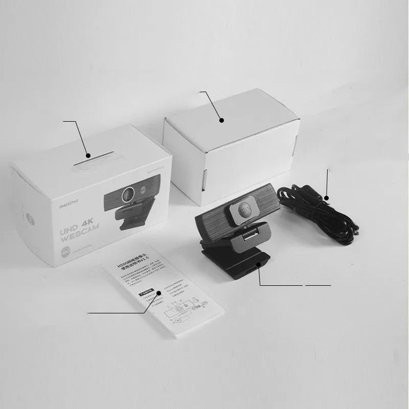 Black computer camera with magnetic privacy cover attached, showing USB cable connection