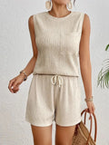 Solid colour apricot polyester sleeveless vest and matching shorts co-ord set laid flat.
