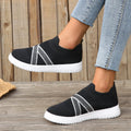Black women's flat casual shoes with fabric mesh uppers, tassel detail, and a rubber sole.