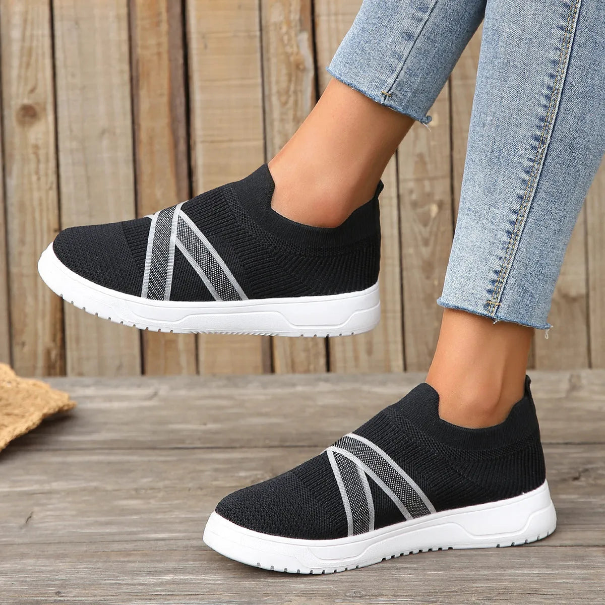 Black women's flat casual shoes with fabric mesh uppers, tassel detail, and a rubber sole.