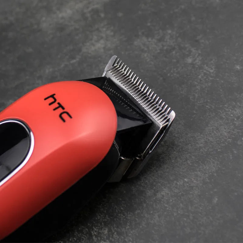 Black professional digital hair clipper and trimmer kit with charger, 4 comb guides, oil, and cleaning brush on a white background.
