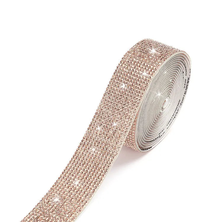 Close-up of a self-adhesive electroplated glass crystal strip on a roll for clothing decoration.