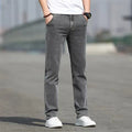 Men's smoky grey straight leg jeans with low waist design and zipper fly closure
