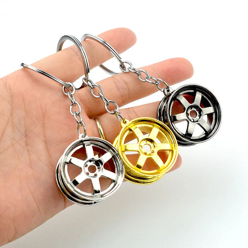Creative car modification wheel hub metal keychain in gold finish on a keyring