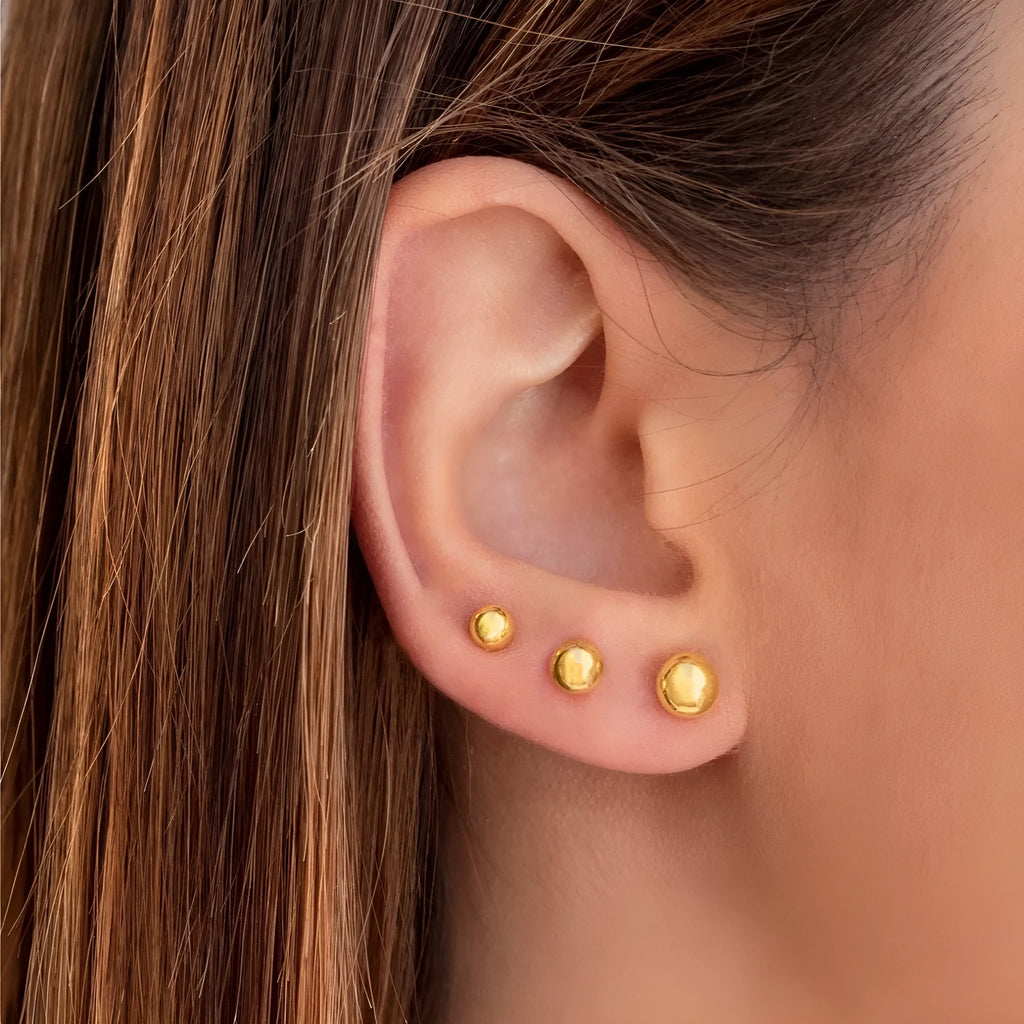 Stainless steel round ball stud earrings in gold or silver, showing 3mm, 4mm, 5mm, and 6mm size options.