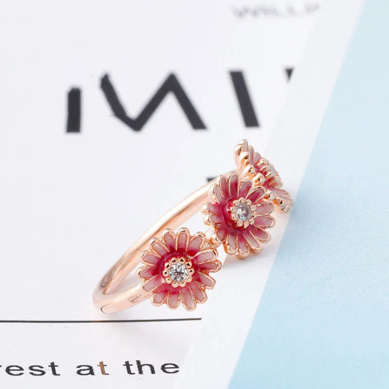Three pink daisy rings with pink gemstone inlay in 925 sterling silver