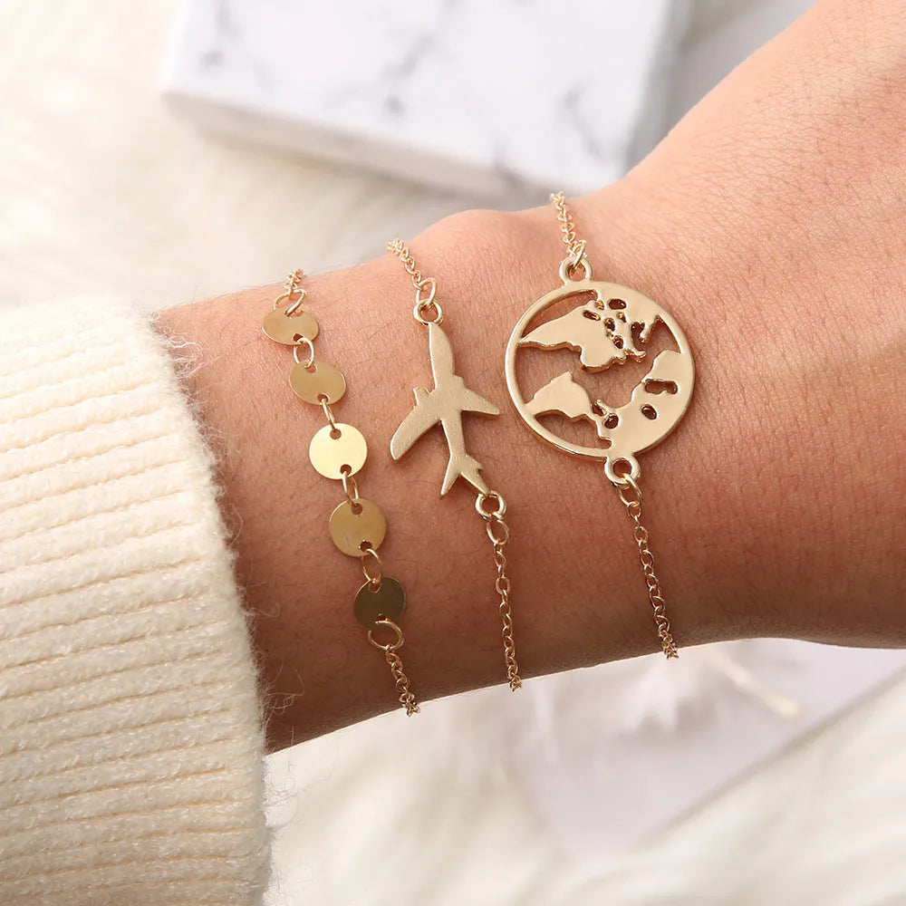 Set of three women's bohemian bracelets with heart-shaped aircraft map charms in alloy metal.