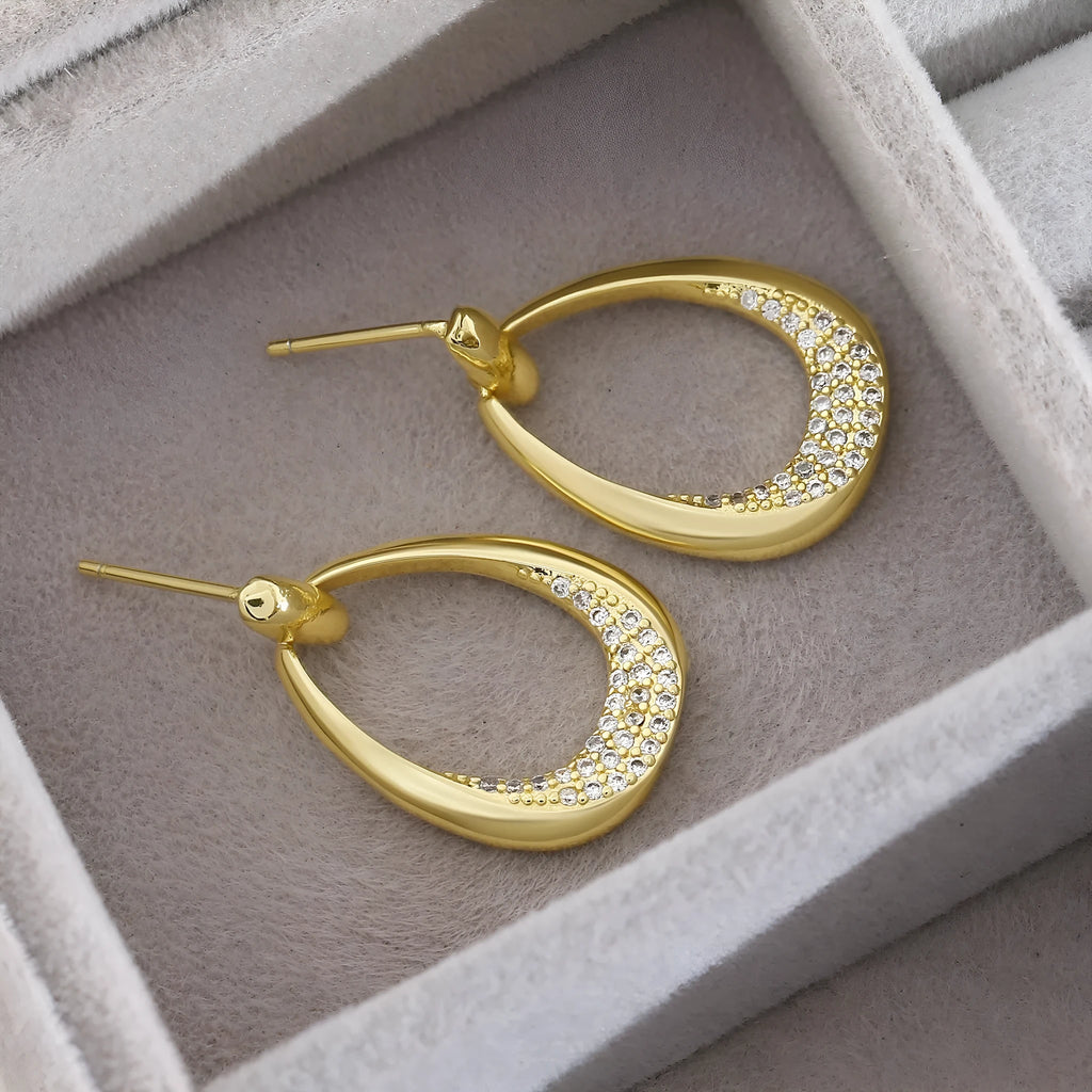 Yellow gold geometric women's drop earrings with a ring design and zircon detail on a white background.