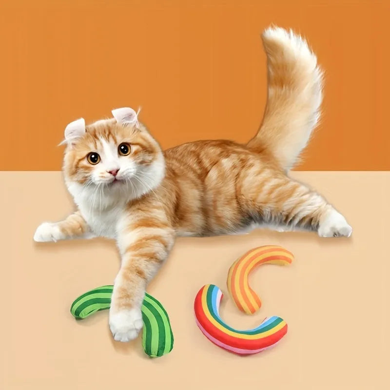 Cat toy set showing noise-making toy with catnip strip and striped pattern cat pillow in green, rainbow, or yellow