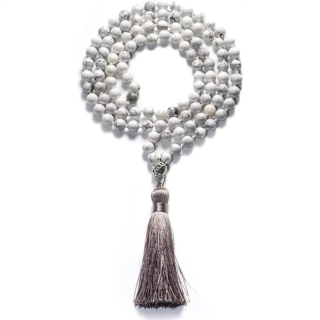 Long multicoloured agate tassel necklace with geometric beads and a flowing pendant.