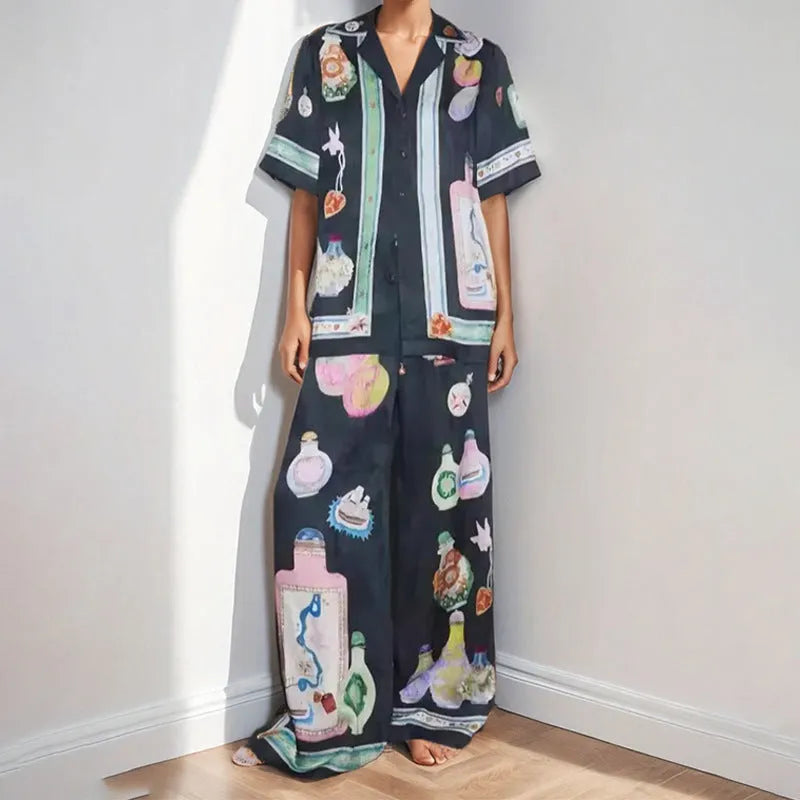 Black women's casual set with cartoon pattern, featuring a short sleeve cardigan and matching trousers.