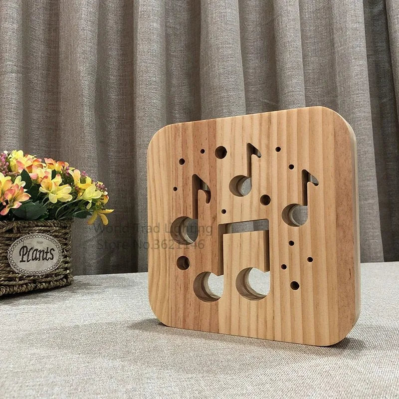 Square pine wood USB LED atmosphere lamp emitting warm white light from its 3D design.
