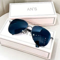 Aviator-style sunglasses with a metal frame and tinted resin lens, shown in a gold frame variant.
