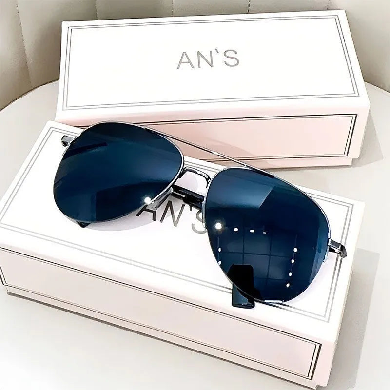 Aviator-style sunglasses with a metal frame and tinted resin lens, shown in a gold frame variant.