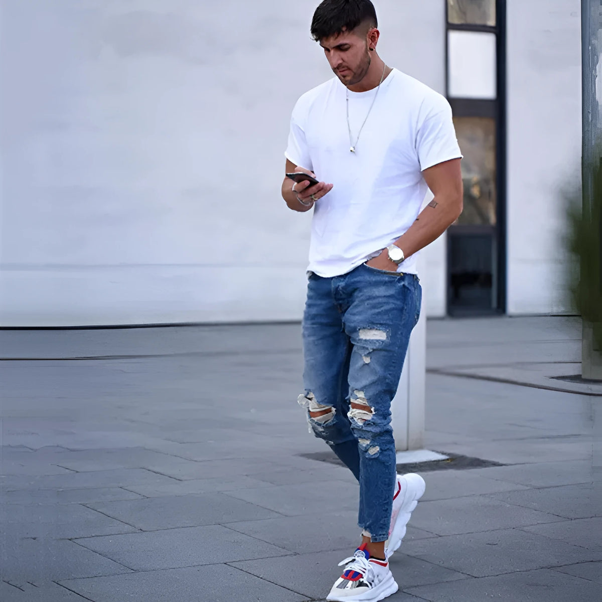 Deep blue men's jeans showing distressed hole details on the legs