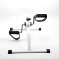 White mini exercise bike with non-slip pedals and monitor on rubber feet