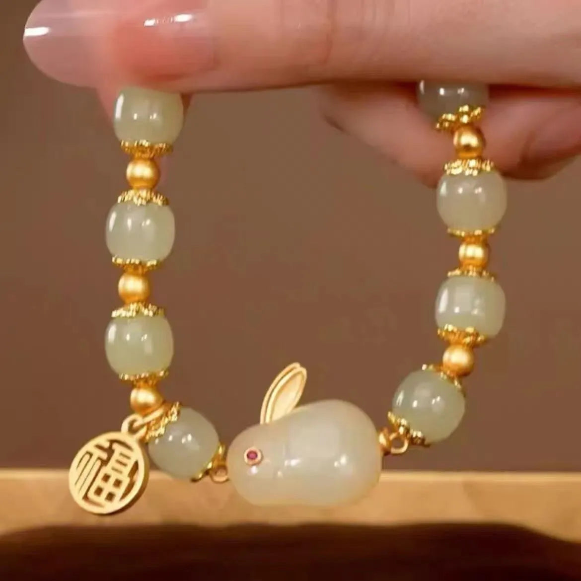 Green jade and black cord women's bracelet with fu character and hare pendant charms