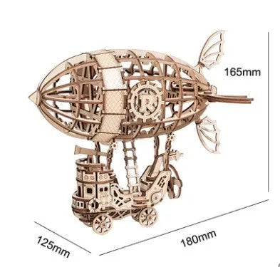 Four wooden 3D puzzle models showing an Airship, Balloon, Radio, and Pumpkin Carriage