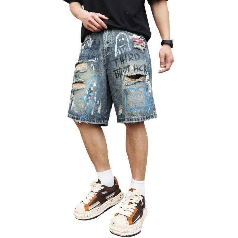 Blue ripped men's denim shorts with graffiti design, showing straight leg and zipper fly.