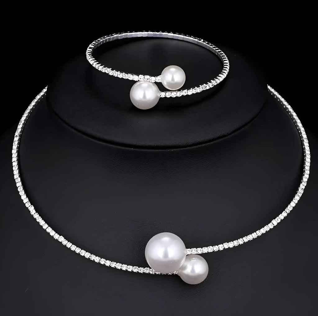 Bridal crystal pearl diamond drill collar necklace and bracelet set in gold and silver tones on white background