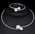 Bridal crystal pearl diamond drill collar necklace and bracelet set in gold and silver tones on white background