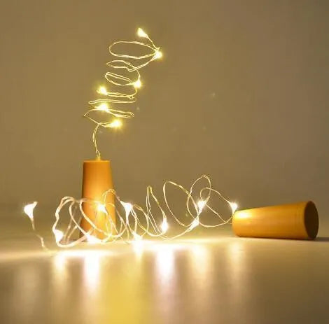 Flexible copper wire LED string light with bottle stopper for wine bottle decoration.