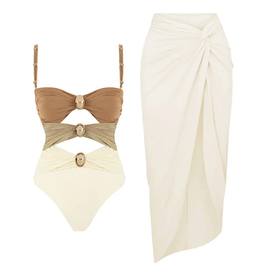 Women's solid colour one-piece swimsuit with matching skirt and gold button detail