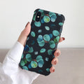 Black silicone iPhone case featuring a detailed leaf print design on the back.