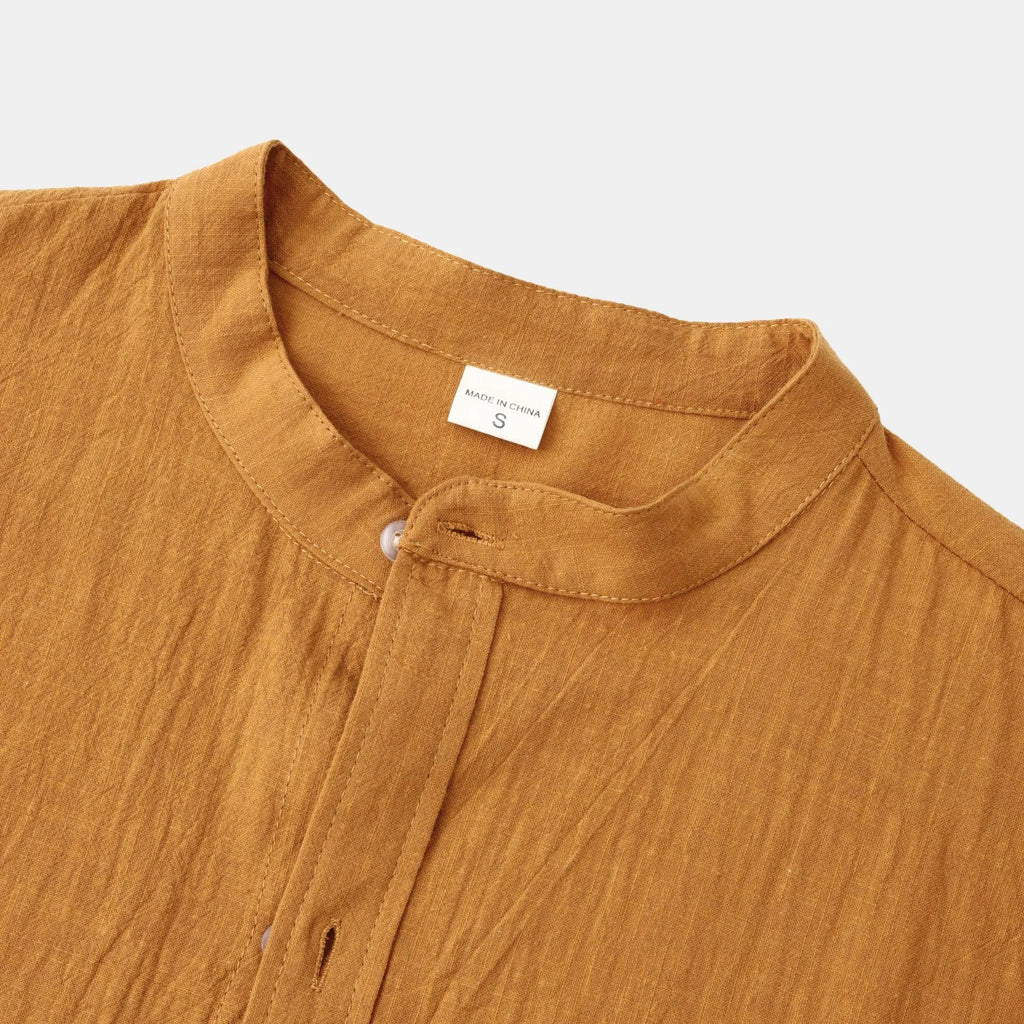 Men's slim fit brown cotton blend long sleeve shirt and matching casual trousers laid flat.