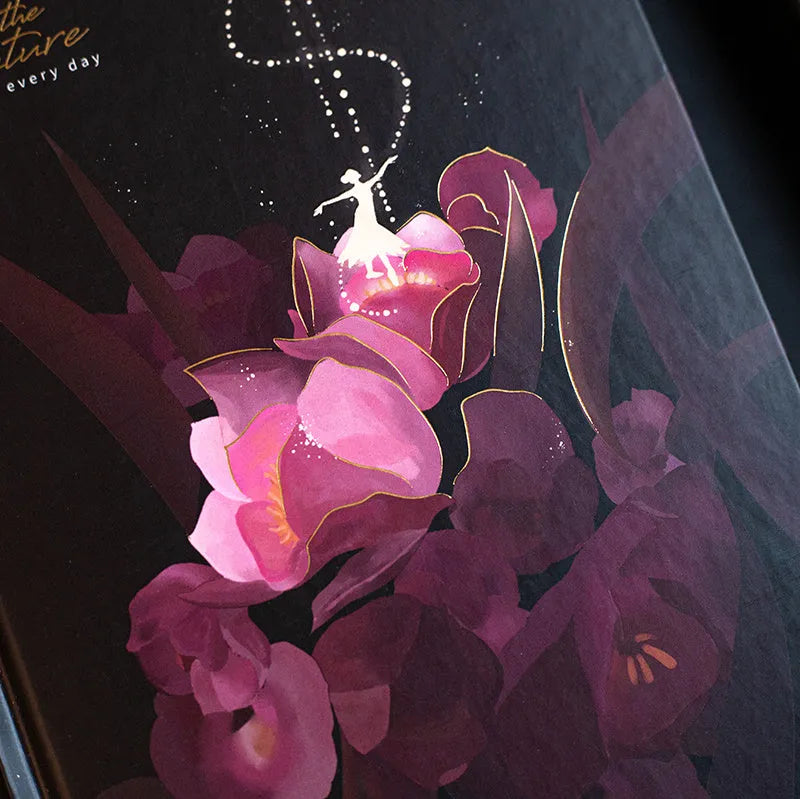 A5 size notebook with a luminous cover, open to show colour illustration pages and lined 160gsm paper.