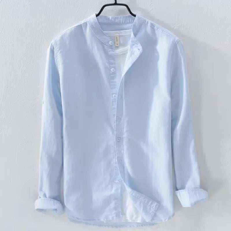 Man wearing a loose-fit light blue casual long sleeve shirt made from cotton linen fabric.