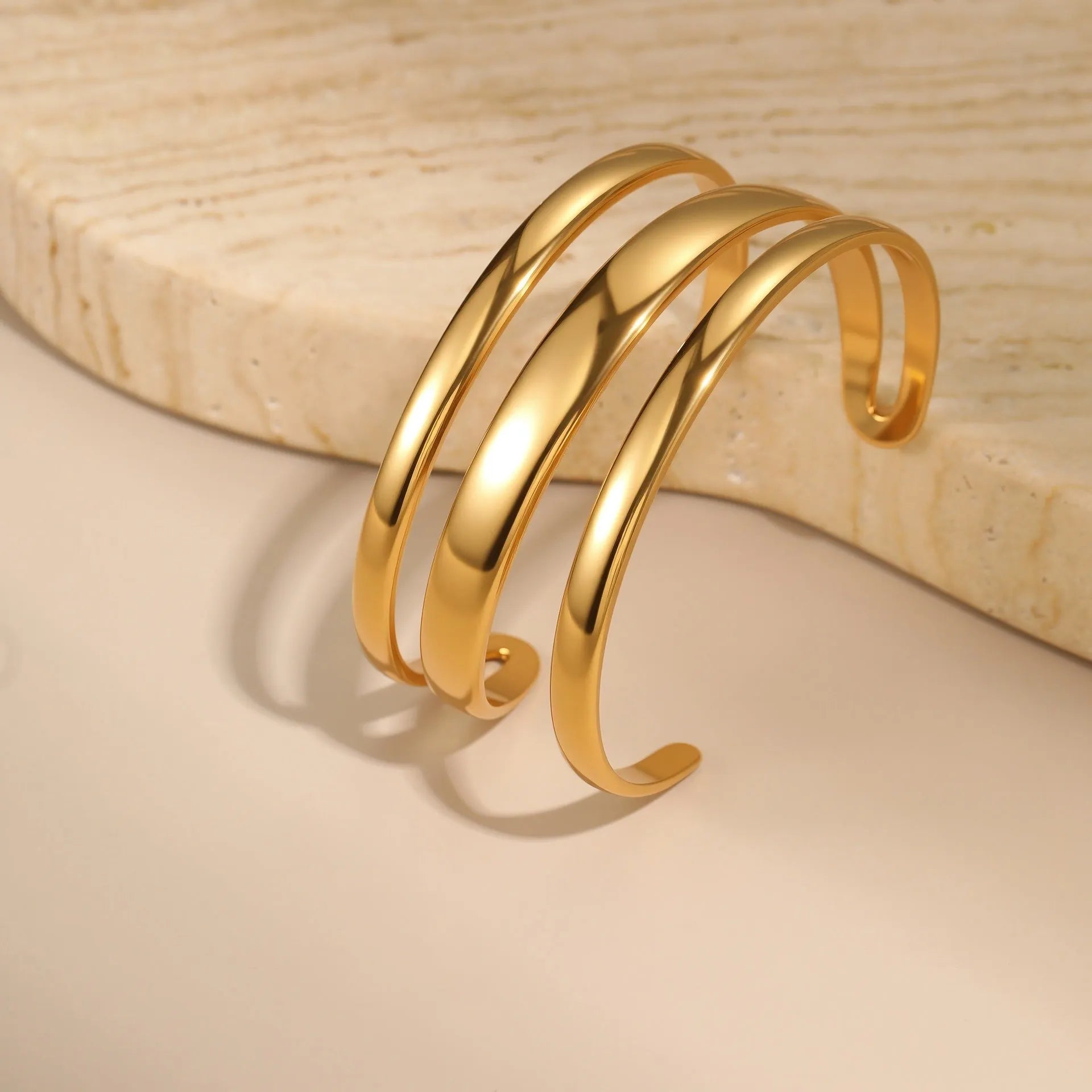 A geometric line design bracelet for women on wrist, shown in stainless steel with a simple opening clasp.