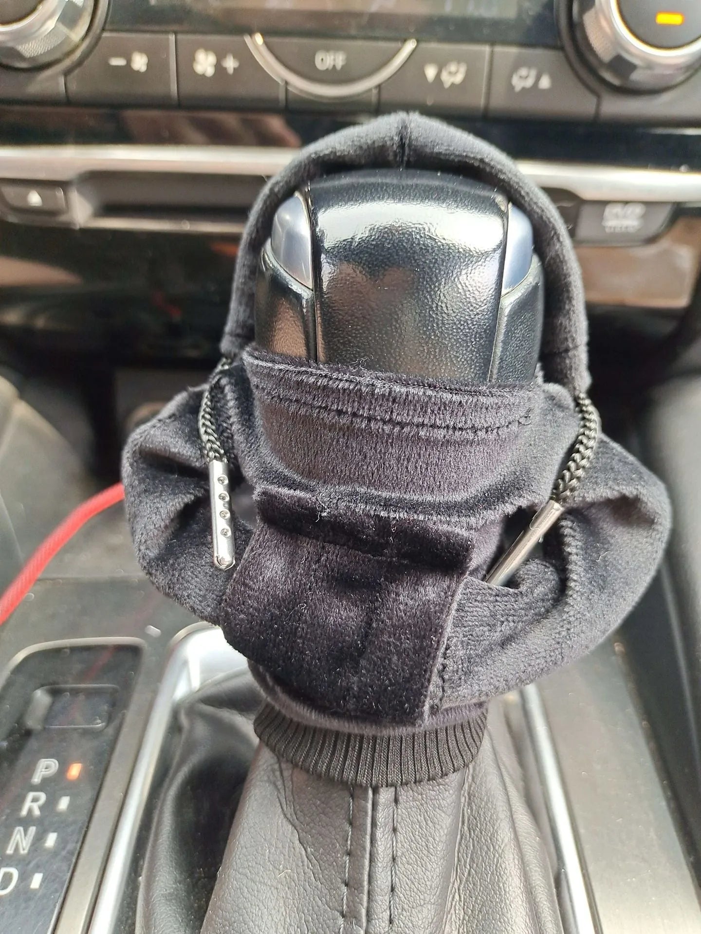 Pure cotton knitted gear lever sweater decoration in various colours on a car gear stick.
