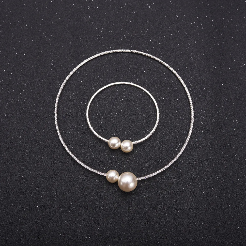 Bridal crystal pearl diamond drill collar necklace and bracelet set in gold and silver tones on white background