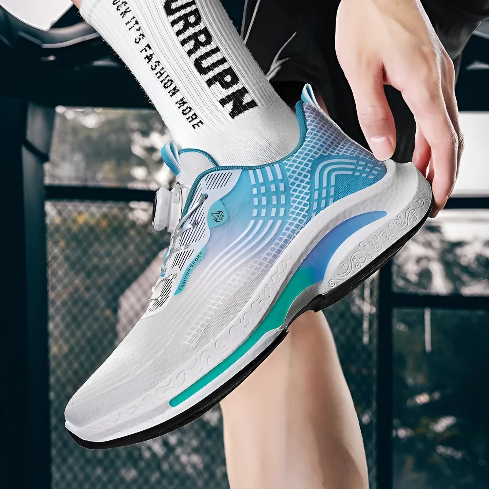 Men's low-top sneaker with a rotating buckle closure and breathable mesh lining on a rubber sole.