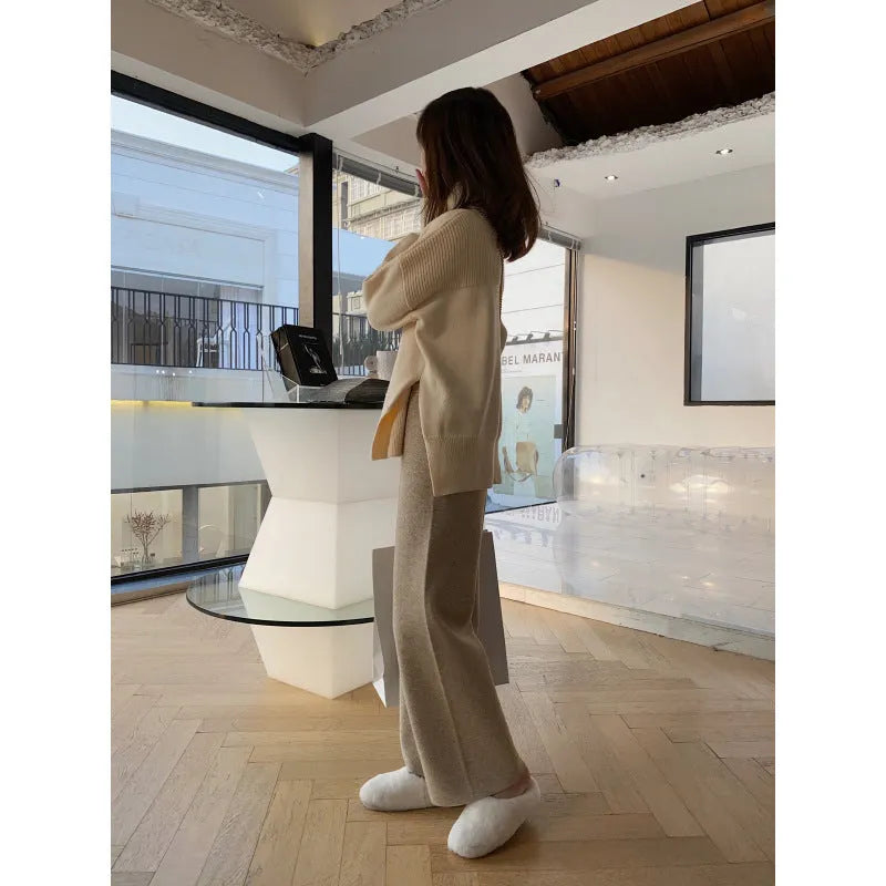 Women's high-waist knitted wide-leg trousers in cream white, showing straight-leg cut and drooping hem.