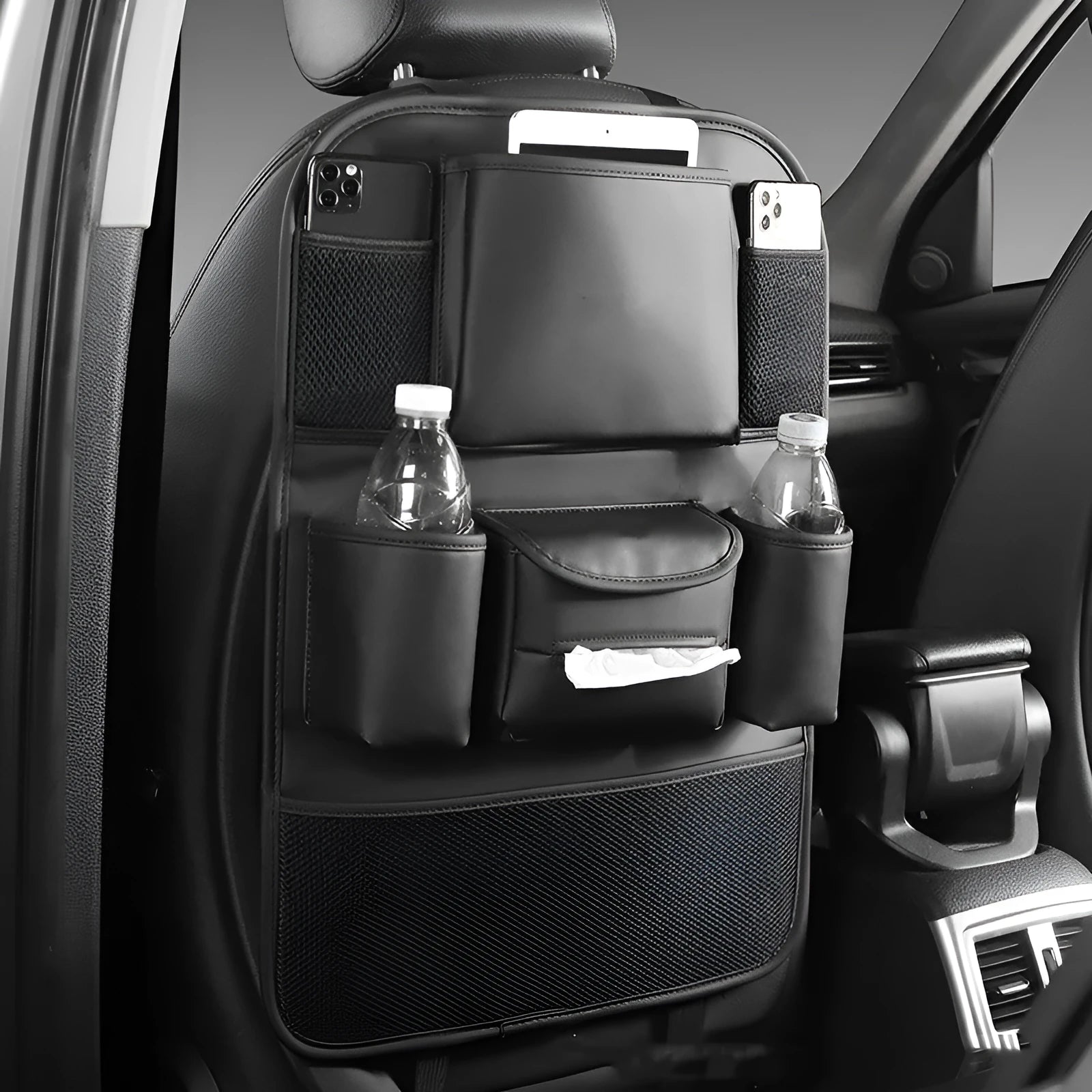 Leather car seat back storage bag in a choice of colours, shown hanging from a vehicle headrest.