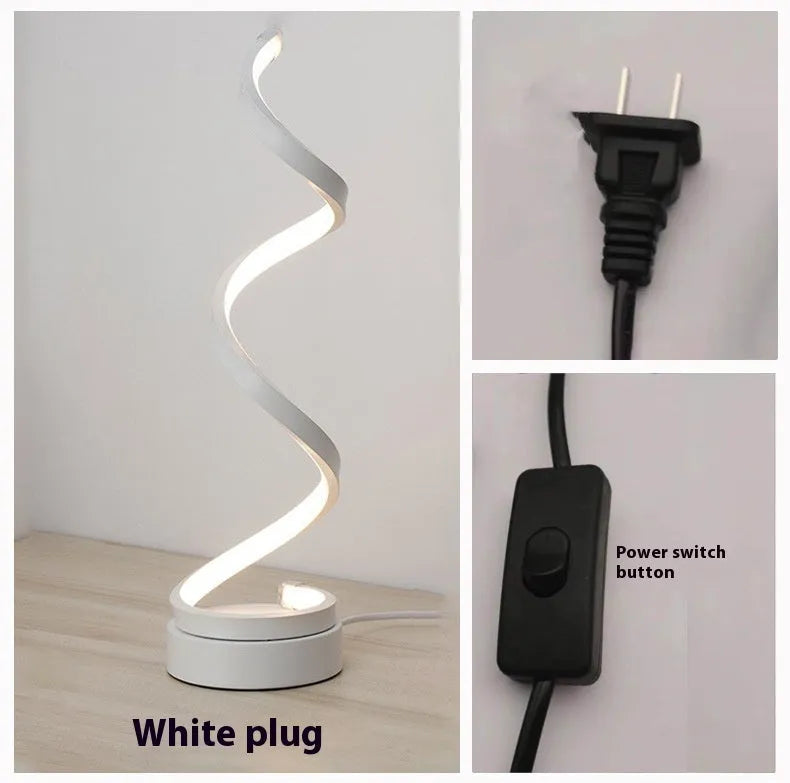 Black minimalist LED bedside table lamp with aluminium shade and metal base on wooden table