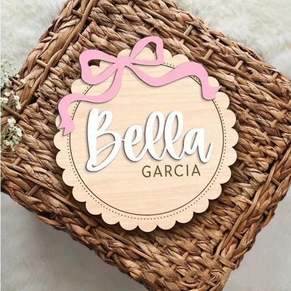 Square wooden baby room ornament personalised with a name, shown in 13cm and 15cm sizes.